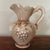 Vintage Grape Embossed Pitcher Featuring Florals with Scrolled Rim Based in unmarked; it may be Italian pottery. Measures...