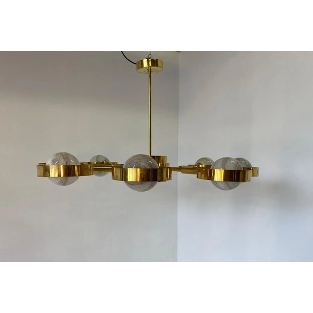Italian Art Deco Murano colored glass on a brass structure, produced in Italy, in Murano by master glass craftsmen. Up to...