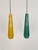 Beautiful pair of two XL glass pendant lights in different, shiny colors: petrol-green and yellow, inside the glasses is a...
