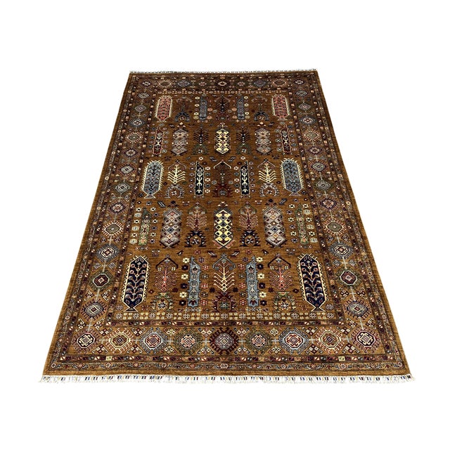 This Afghan Sultani wool area rug features a warm walnut brown field with geometric medallions, stylized trees, small...