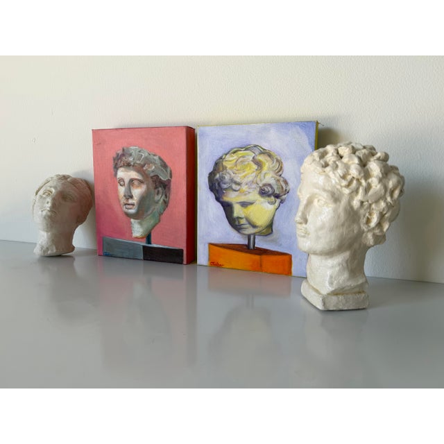 A compelling pair of contemporary pottery bust sculptures by artist Cris Cooper, created circa 2016. Inspired by classical...