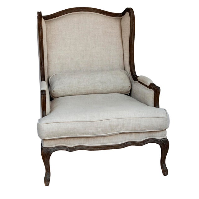 A Vintage Restoration Hardware, Wingback "Lorraine Chair". Traditional Rococo carvings and ornamentation have been...