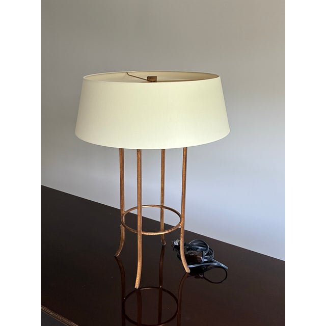 Elegant designer table lamp by Baker Furniture for the Milling Road collection, featuring a refined open cage form in a...