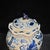 Remarkable Chinese blue and white porcelain jar topped with a ruffled lotus-leaf shaped lid crowned by a sculpted finial....