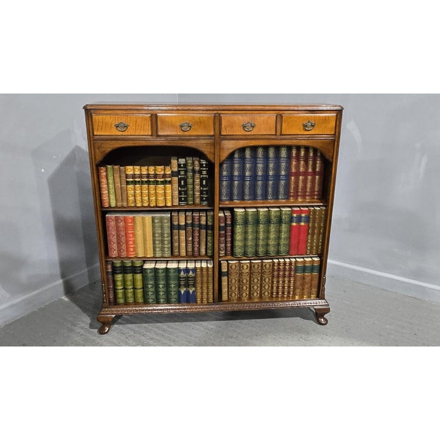 Excellent quality and condition, French walnut open library bookcase with adjustable shelving, standing on squat cabiole...