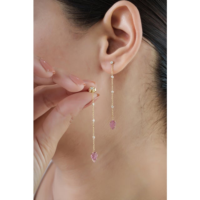 These chain drop earrings feature 0.82 carats of carved pink tourmaline, set in 14K yellow gold. Each measuring...