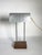 Minimalist desk lamp with aluminum shade and wooden base, France, 20th century. Clean and functional, this table lamp...