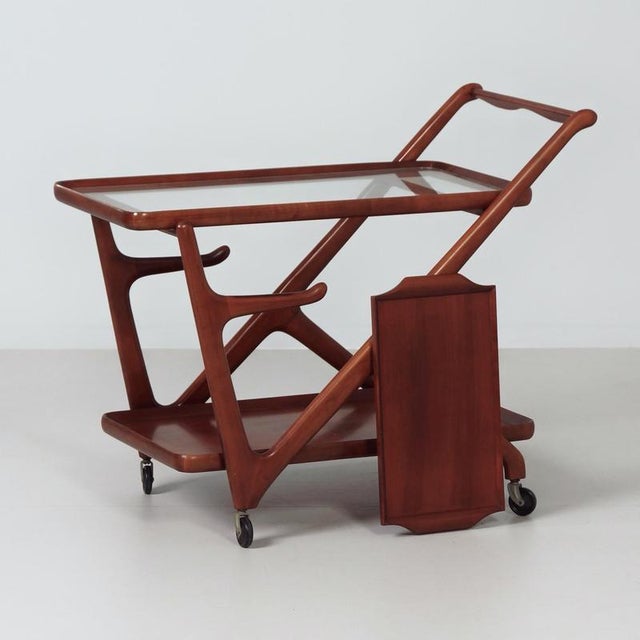 Cesare lacca serving trolley from the 1960s, an elegant example of italian modern design. The organic wooden frame, the...