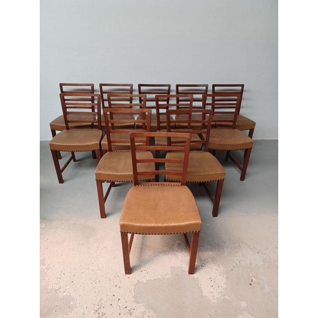 Set of twelve Danish Mid-Century mahogany dining chairs customized upholstery included. The very well crafted set of...
