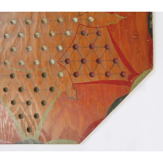 Circa 1930s octagon shaped handmade early plywood Chinese checkers game board with handpainted decoration in green, red...