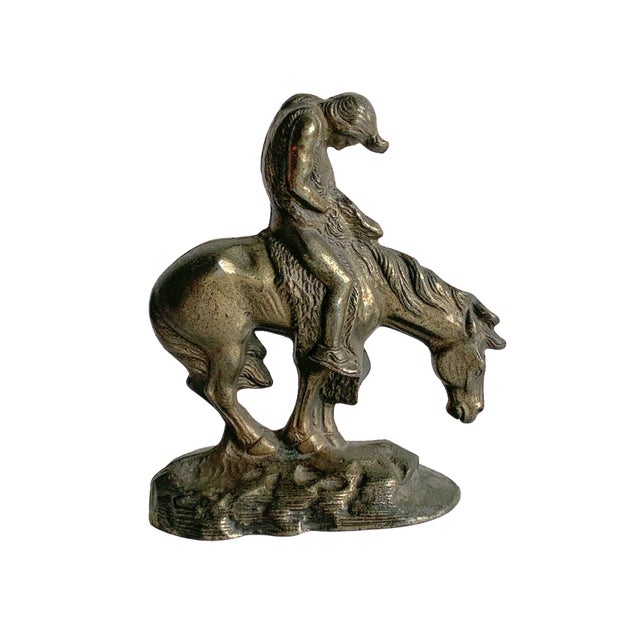 Cast iron figural sculpture depicting the iconic “End of the Trail” composition, portraying a Native American figure...