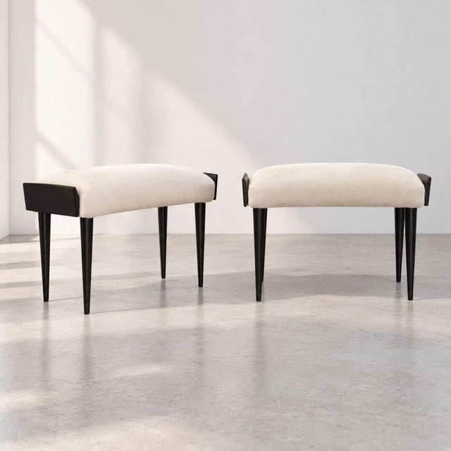 A refined pair of Italian Mid-Century Modern poufs from the 1950s, crafted from ebonized wood and featuring an elegant,...
