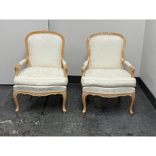Design Plus Gallery presents a Pair of Vintage Louis XV Style Fauteuil Armchairs by Sofa In. Each chair has a carved wood...