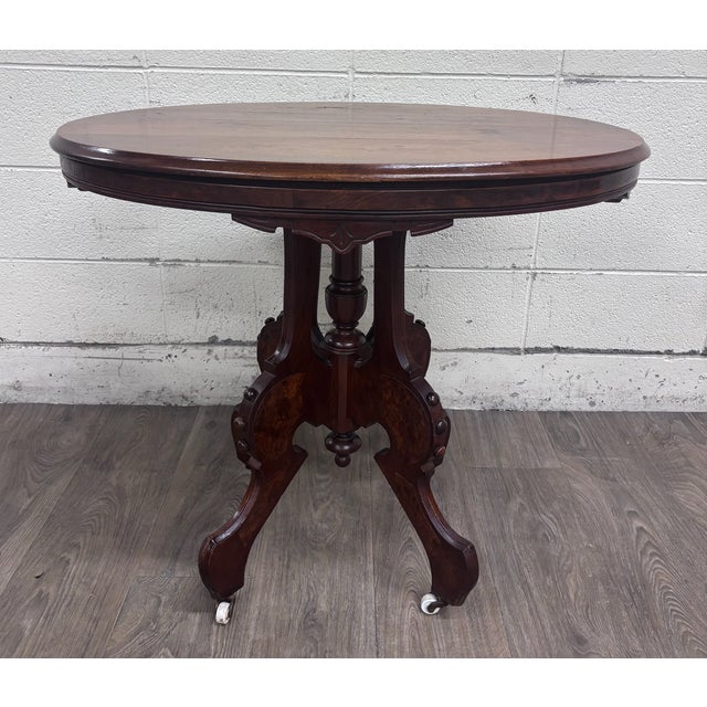 This is a stunning antique Victorian Eastlake burl walnut oval center/parlor table crafted in walnut with richly figured...