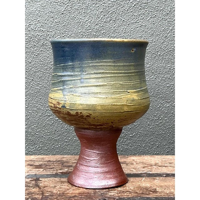 This vintage textured ceramic chalice vase presents a striking goblet-form silhouette, its rounded, cup-like body rising...