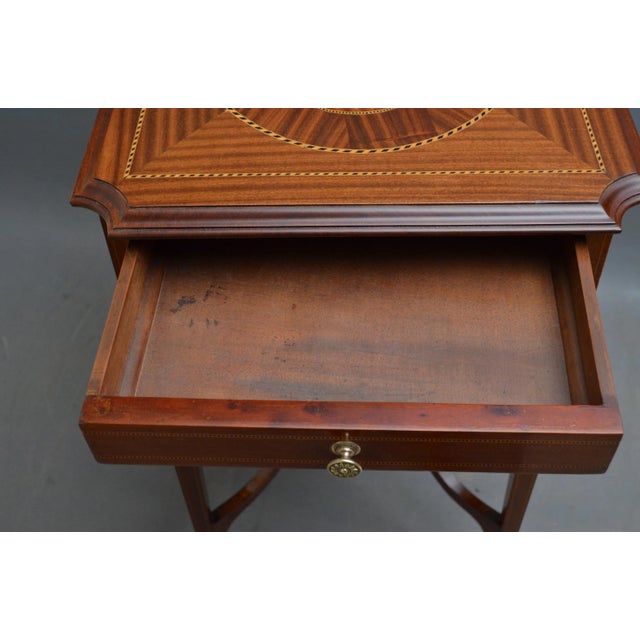 A very attractive edwardian, mahogany table, having shaped top with geometrically inlaid top, practical frieze drawer and...