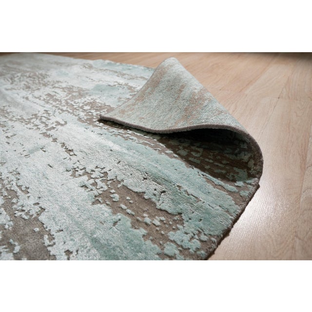 Hand-knotted in wool, this 8 x 10 Amara Captivating Silver rug carpet is a refined addition to our contemporary room-size...