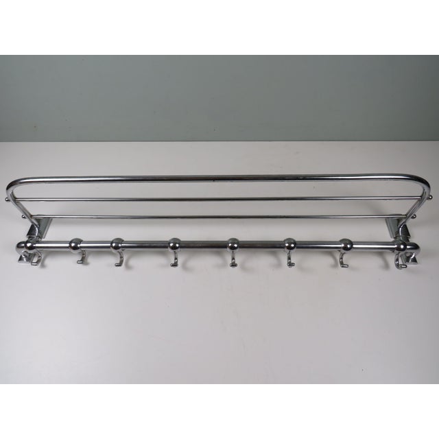 Elegant modernist wall-mounted coat rack from the 1920s, executed in the Bauhaus tradition with subtle Art Deco...