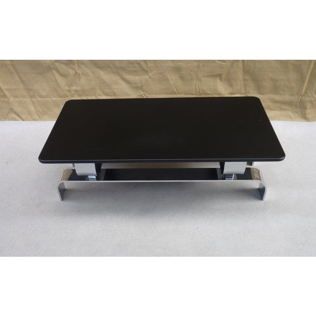 Coffee table with a 12mm chromed steel frame and a black PU lacquered MDF top. A beautiful piece with lovely chrome...