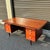Sit down and start that novel you’ve been meaning to write. This vintage teak executive desk features a floating top, four...