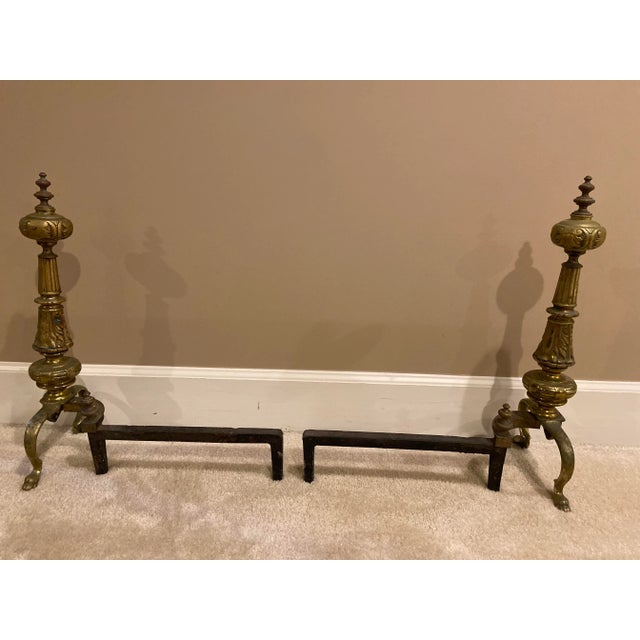 Rare pair cast iron and brass andirons circa 1920-30. Incredible sculptural details. Notice the stylized pair of curved...