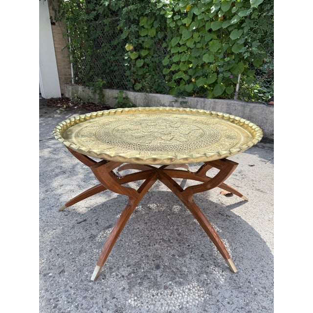Vintage Folding Moroccan Embossed Brass Tray Coffee Table with Wooden Spider-Leg Base and Brass Metal Feet. Unmarked. In...