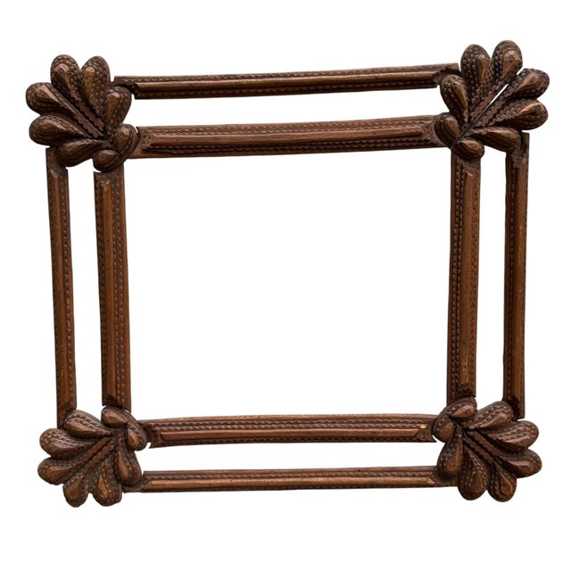 A tramp art frame, hand-crafted in the classic American folk-art tradition and dating to the Depression era (c. 1930s)....