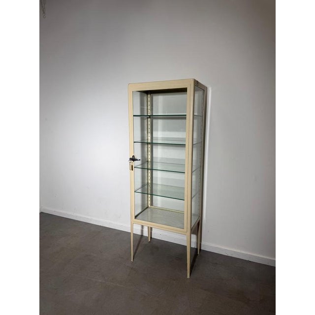 Authentic 1950s vintage medical cabinet, a beautifully preserved piece of mid-century functional design. Originally used...