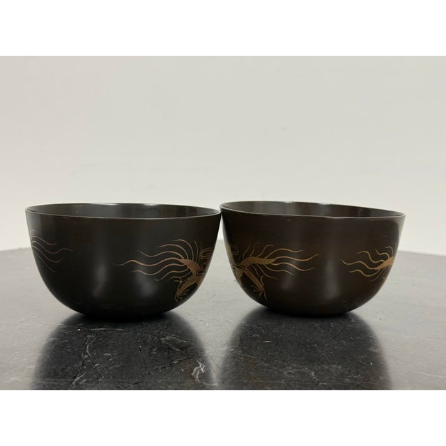 Design Plus Gallery presents a pair of Japanese Lacquer Dragon Bowls. Each bowl has a rounded form with a black lacquered...