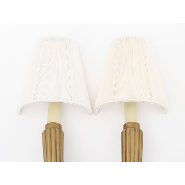 Pair of Art Deco Style Brass Two-Branch Wall Sconces, each with two fluted arms with candlestick style lights and cloth...