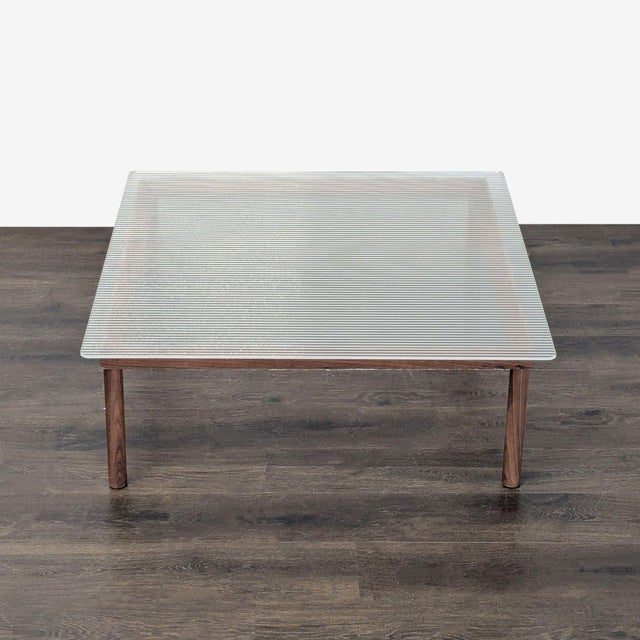 The table was designed by Martin Solem, a Norwegian designer from Copenhagen. It has a reeded glass top on a walnut base...