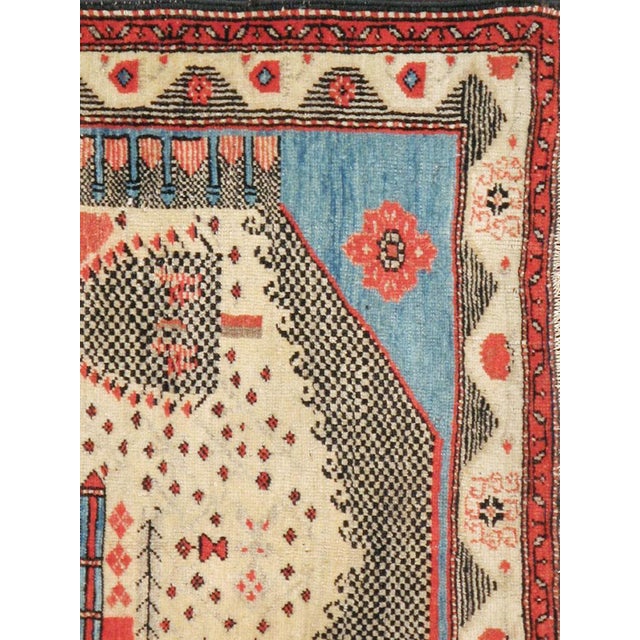 A vintage Turkish Anatolian pictorial rug from the mid-20th century. A self-taught artist has depicted six buildings and...