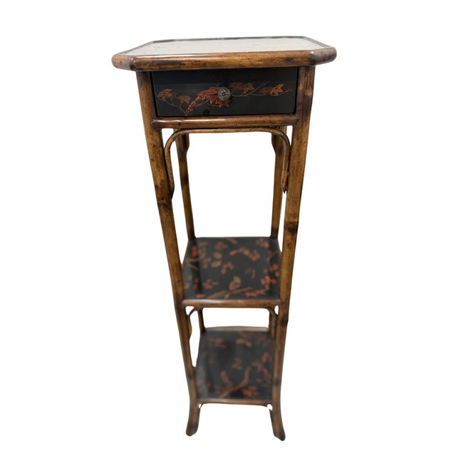 Elegant vintage faux bamboo accent table / plant stand featuring hand-painted chinoiserie floral details and a functional...