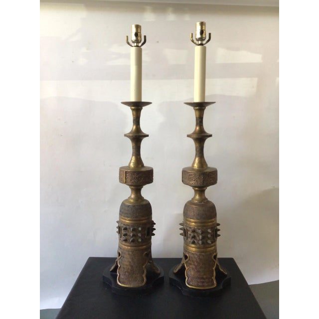 Pair of 1950s James Mont style bronze Asian lamps on metal bases.