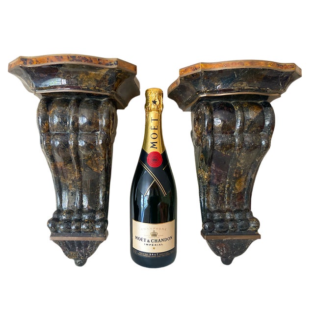 A substantial pair of wall brackets tessellated in pen shell and brass trim over solid wood. Lighter pen shell creates a...