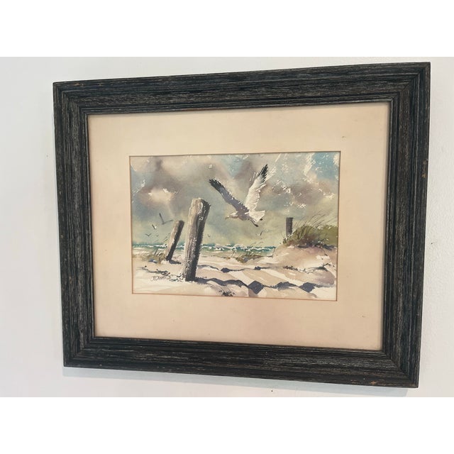 An atmospheric original watercolor by noted American artist J. Everett Draper (1915–2006) depicting seabirds soaring above...