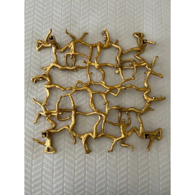 Whimsical figurines connect to form this 3-dimensional wall plaque finished in a metallic gold leaf. Dimensions: 19 W X 19...