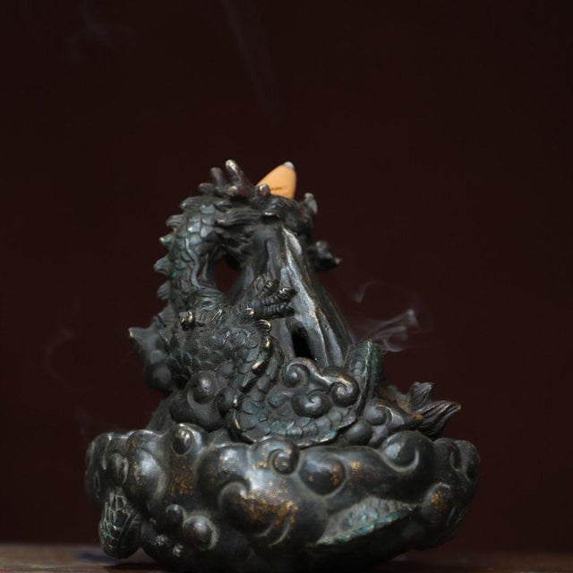 This is a finely cast antique gilt bronze backflow incense burner featuring a dynamic dragon motif. The piece is designed...