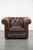 Timeless and luxurious brown Chesterfield armchair made of English-style cowhide. : This beloved brown cowhide...