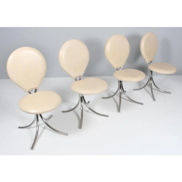 Set of four Poul Hennignsen dining chairs with a frame of tubular chromed steel. Seat and back upholstered with light...