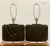 A gorgeous pair of oversized black glazed ceramic lamps from the 1980's. Each lamp features a continual, channeled wave...