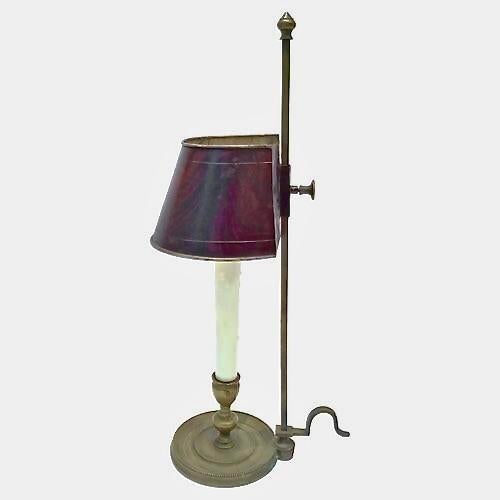Antique brass bouillotte lamp. Demilune tole shade painted with a wood-like finish on an adjustable pole and acorn finial....