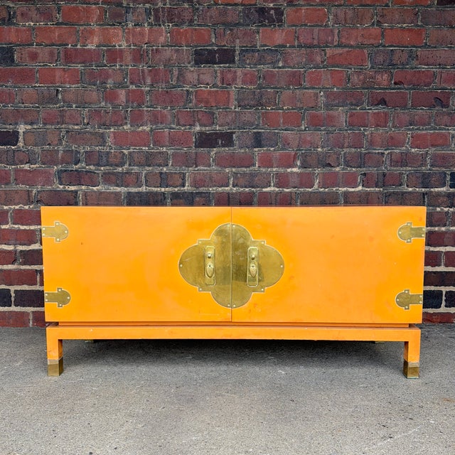 An exceptional Mid-Century Modern credenza featuring elegant Asian-inspired styling, a warm lacquered finish, oversized...