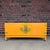 An exceptional Mid-Century Modern credenza featuring elegant Asian-inspired styling, a warm lacquered finish, oversized...