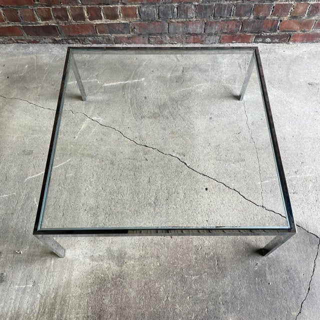 Large chrome frame square coffee table.