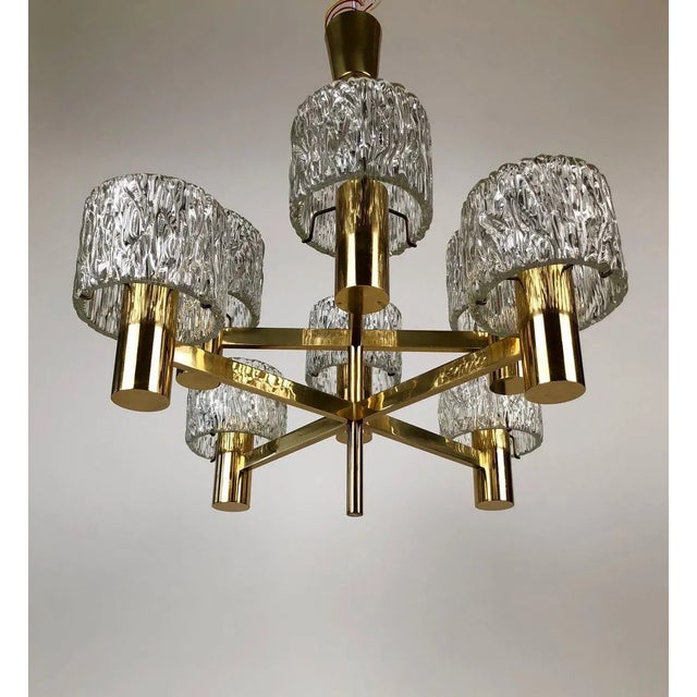Chandelier made from the austrian company j. T. Kalmar in the 60s. Solid brass construction with 8 arms and shades in...