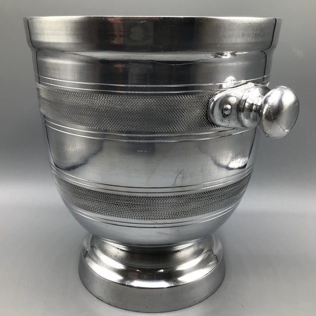 Tall sturdy aluminum champagne/wine cooler with knurled rings and knob handles.