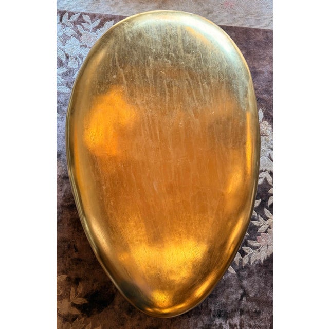 The philips collection river stone coffee table features a unique, organic shape inspired by nature's ability to stones...