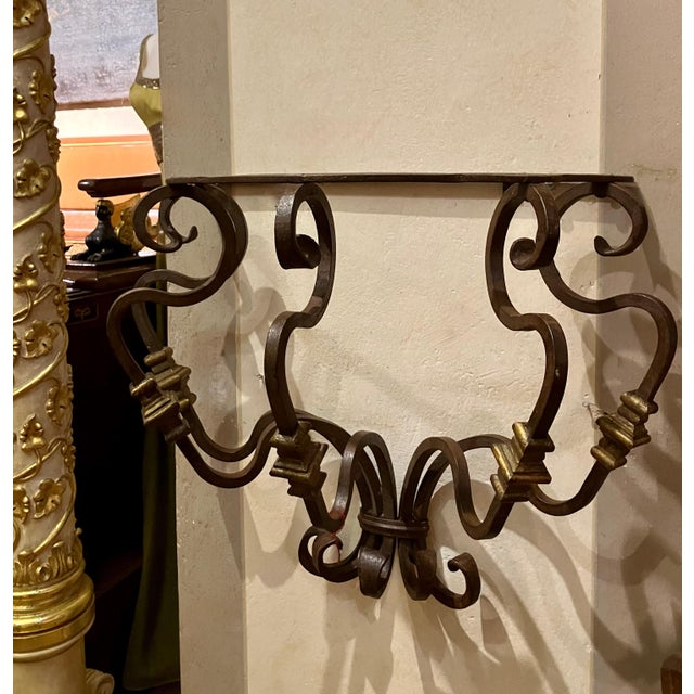 An exceptional and increasingly rare set of four 19th-century Italian wrought iron wall brackets, handcrafted in Tuscany—a...