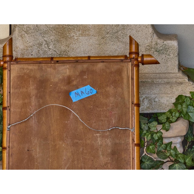 A handsome French faux bamboo mirror from the early 20th century, crafted in solid walnut with distinctive turned elements...